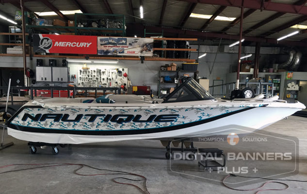 White speedboat with blue wrap